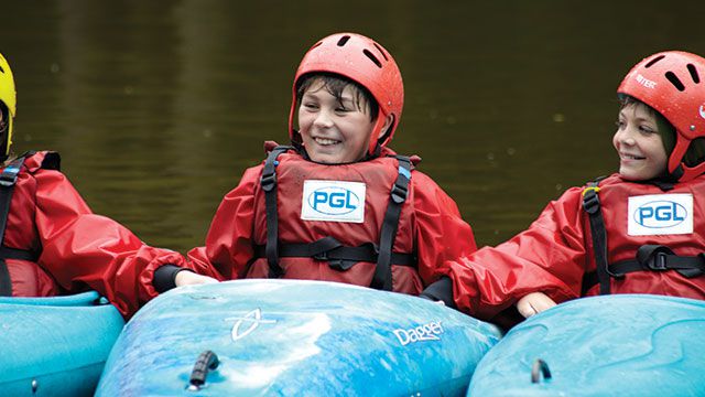 Young boy in a PGL canoe with his friends